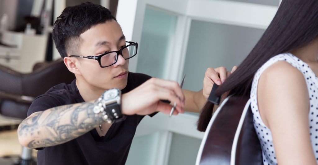 Man working in salon cutting hair